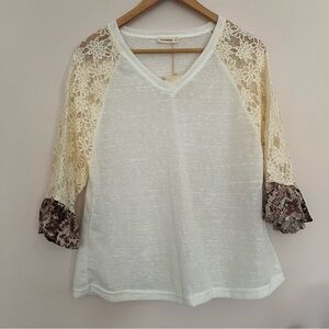 Anythewhy long sleeve top with lace and a snake skin print on the sleeves. Xs